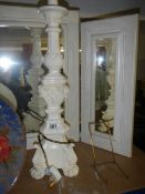 A tall white painted table lamp base.
