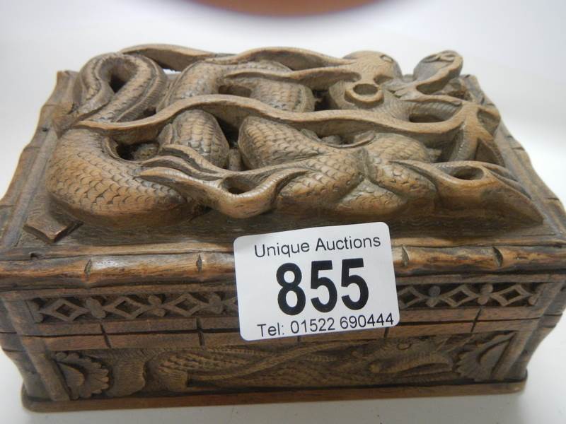 A carved box featuring a Chinese dragon.