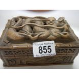 A carved box featuring a Chinese dragon.