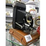 A vintage leather cased folding camera.