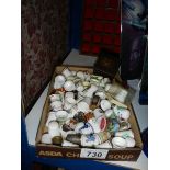 A tray of thimbles and a thimble display shelf,