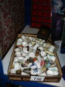 A tray of thimbles and a thimble display shelf,