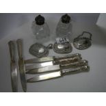 Four silver handles knives, 3 silver plate spirit labels and a pair of salt & pepper pots.