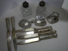 Four silver handles knives, 3 silver plate spirit labels and a pair of salt & pepper pots.