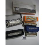 Five old harmonicas.