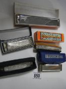 Five old harmonicas.