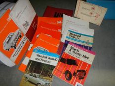 A mixed lot of car service manuals.