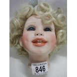 A porcelain dolls head.