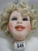 A porcelain dolls head.