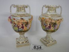 A good pair of small hand painted embossed vases.