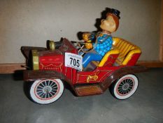 A mid 20th century car with driver toy.