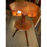 An oxagonal mahogany wig stand on tripod base with two drawers.