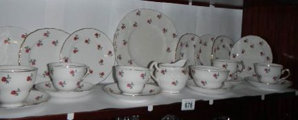 A Colclough rose decorated tea set (missing one tea cup).