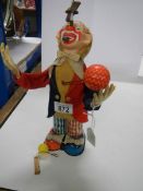 A mid 20th century battery operated clown.