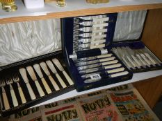 Three cased sets of cutlery.