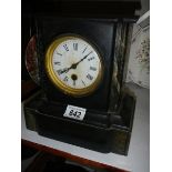 An early 20th century slate mantel clock in working order.