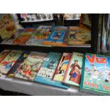 Two shelves of children's books including Rupert, Dandy etc.,