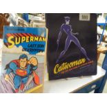 Two comic books - Cat Woman and Superman.