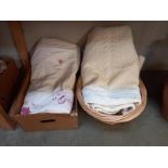 A basket & box of bed spread quilts