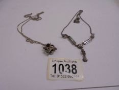 A silver necklace and a silver pendant. 14 grams.
