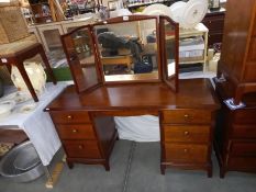 A solid mahogany triple mirror backed dressing table with brass knobs (COLLECT ONLY)