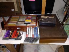 A vintage Binatone transistor radio & varied selection of music cassettes