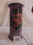 A Longpark Torquay vase with three lips. Brown on the inside, purple outside with flowers.