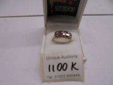 A 9ct gold ring set pink and blue stones, size T, 3.3 grams.