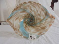 A low glass bowl in blue and gold with swirls round the bowl.