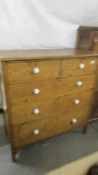 A pine two over three chest of drawers with ceramic knobs. COLLECT ONLY.
