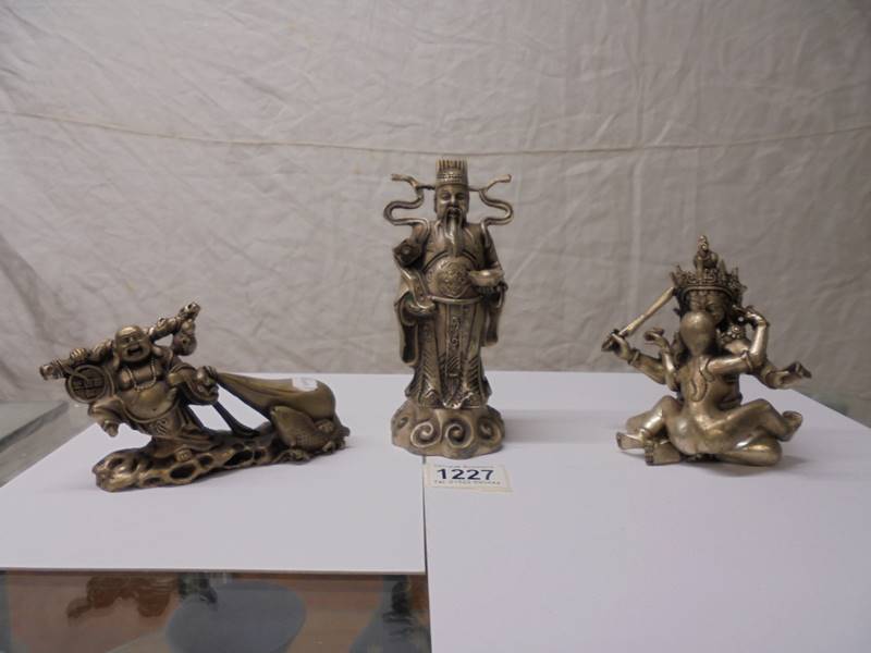 A Chinese silver plated erotic figure group and two Buddha figures.