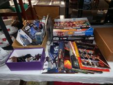 A collection of Star Wars items including figures, cards, books & games including Monopoly & model