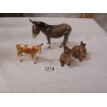 A Beswick donkey, calf and two rabbits.