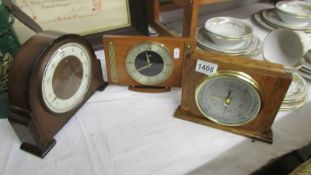 An oak cased barometer and two old mantel clocks.