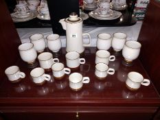 A stoneware coffee pot & 6 stemmed cups (no handles) & a quantity of Denby cups (2 sizes)