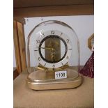 A Junghans ATO glass dome clock, 7 jewel. electro magnetic, in working order.