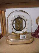 A Junghans ATO glass dome clock, 7 jewel. electro magnetic, in working order.