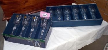 A boxed set of 6 Bohemia cut glass wine glasses and a boxed set of 4 Cristal D'Arques cut glass wine