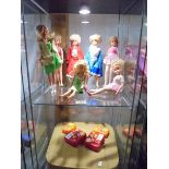 A quantity of Sindy Dolls and Barbie dolls with accessories in a vintage vanity case.