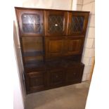A dark wood stained side board/wall unit
