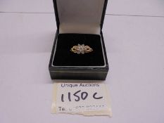 A 14k gold and CZ cluster ring, size P half, 2.9 grams.