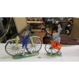 An Italian ceramic male and female figures on bicycle and penny farthing, (man missing right arm