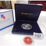 A cased 'The Royal British Legion' silver poppy coin and one other.