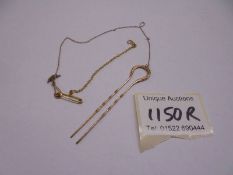 A gold hair pin with safety chain,