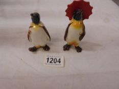 Two Beswick penguins.