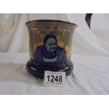 An attractive Doulton D2385 painted plant pot showing an innkeeper and his inn.