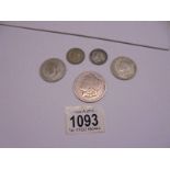 An 1878 US silver dollar and four UK silver coins, 64 grams.