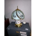 A Tiffany style touch lamp with integral clock