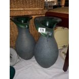 A pair of green pottery vases, 41cm high