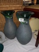 A pair of green pottery vases, 41cm high